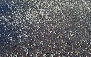 A large amount of de-icing salt on a concrete parking space.